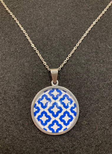 Chain with a blue/white pattern behind glass and stainless steel